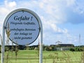 Golf course warning sign on the island of Sylt in Wenningstedt.