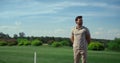 Golf course worker enjoy sunny day. Golfer inspecting player at fairway field. Royalty Free Stock Photo