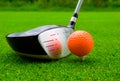 Golf driver with orange ball. Royalty Free Stock Photo