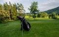 Golf equipment at the course on sunny day. Golf bag on the fairway Royalty Free Stock Photo