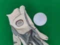 Golf equipment on green background ball gloves tee and golf club driver Royalty Free Stock Photo