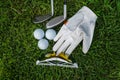 Golf equipment on green grass, ball, glove, tee and golf-club driver, golf gear and equipment on flat lay top view
