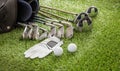 Golf equipment on green grass golf course, close up view