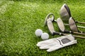 Golf equipment on green grass golf course, close up view