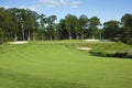 Golf fairway and green with bunkers Royalty Free Stock Photo