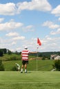 Golf - Father Putting Ball at Son Tending Flag Royalty Free Stock Photo