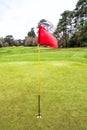 Golf field with red flag Royalty Free Stock Photo