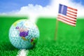 Golf globe world ball with USA flag on green lawn or field. Royalty Free Stock Photo