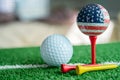 Golf globe world ball with USA flag on green lawn or field, most popular sport in the world Royalty Free Stock Photo