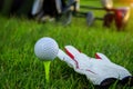 Golf glove , white golf ball on tee in a beautiful golf course Royalty Free Stock Photo