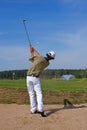 Golf, golfer striking the ball from the bunker Royalty Free Stock Photo