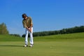 Golf, Golfer thrusting the ball into the hole Royalty Free Stock Photo