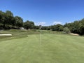 Rear shot of nice golf hole with flag and green Royalty Free Stock Photo