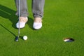 Golf green hole course man putting short ball Royalty Free Stock Photo