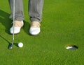 Golf green hole course man putting short ball Royalty Free Stock Photo