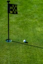 Golf hole. Golf ball on lip of cup on grass background. Royalty Free Stock Photo