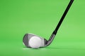 Golf Iron Club Head and Ball on a Green Background Royalty Free Stock Photo