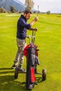 Golf player and his golf clubs Royalty Free Stock Photo