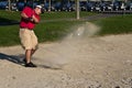 Golf player hitting the ball from the sand bunker Royalty Free Stock Photo