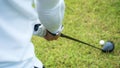 Golf player hitting beautiful shot with club on course in the park Royalty Free Stock Photo