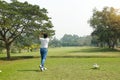 Golf player hitting shot with club on course Royalty Free Stock Photo