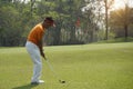 Golf player hitting shot with club on golf course Royalty Free Stock Photo