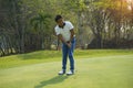 Golf player hitting shot with club on golf course Royalty Free Stock Photo