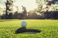 golf player putting golf ball into hole Royalty Free Stock Photo