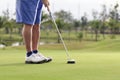 Golf player putting on the green Royalty Free Stock Photo