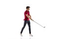 Golf player in a red shirt taking a swing isolated on white studio background Royalty Free Stock Photo