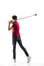 Golf player in a red shirt taking a swing isolated on white studio background Royalty Free Stock Photo