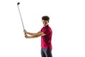 Golf player in a red shirt taking a swing isolated on white studio background Royalty Free Stock Photo