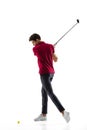 Golf player in a red shirt taking a swing isolated on white studio background Royalty Free Stock Photo