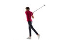 Golf player in a red shirt taking a swing isolated on white studio background Royalty Free Stock Photo