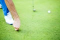 Golf player repairing divot