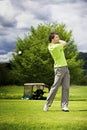 Golf player teeing off Royalty Free Stock Photo