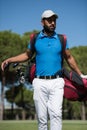 Golf player walking and carrying bag Royalty Free Stock Photo