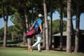 Golf player walking and carrying bag Royalty Free Stock Photo