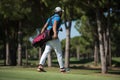 Golf player walking and carrying bag Royalty Free Stock Photo