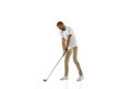 Golf player in a white shirt practicing, playing isolated on white studio background