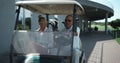 Golf players sit cart get ready outside. Active couple going drive car on course Royalty Free Stock Photo