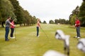 Golf Professional Demonstrating Tee Shot To Group Of Golfers During Lesson Royalty Free Stock Photo