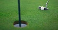 Golf professional play ball in golfing hole. Golfer swing club on green course. Royalty Free Stock Photo