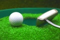 Golf and with putter on green background Royalty Free Stock Photo