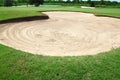 Golf: sand trap on the green grass Royalty Free Stock Photo