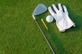 The golf sport equipment  white glove ,golf ball, golf club and  yellow tee golf with green grass Royalty Free Stock Photo