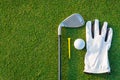 The golf sport equipment  white glove ,golf ball, golf club and  yellow tee golf with green grass Royalty Free Stock Photo