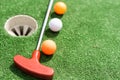 Golf stick and ball on green grass close up. Royalty Free Stock Photo