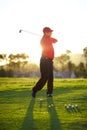 Golf, stroke and man with club on course outdoor for training, workout or fitness on sunset mockup space. Golfing Royalty Free Stock Photo