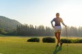 Golf women. Cheerful happy asian smiling woman with playing golf in the golf club in the sunny and evening sunset time, Royalty Free Stock Photo